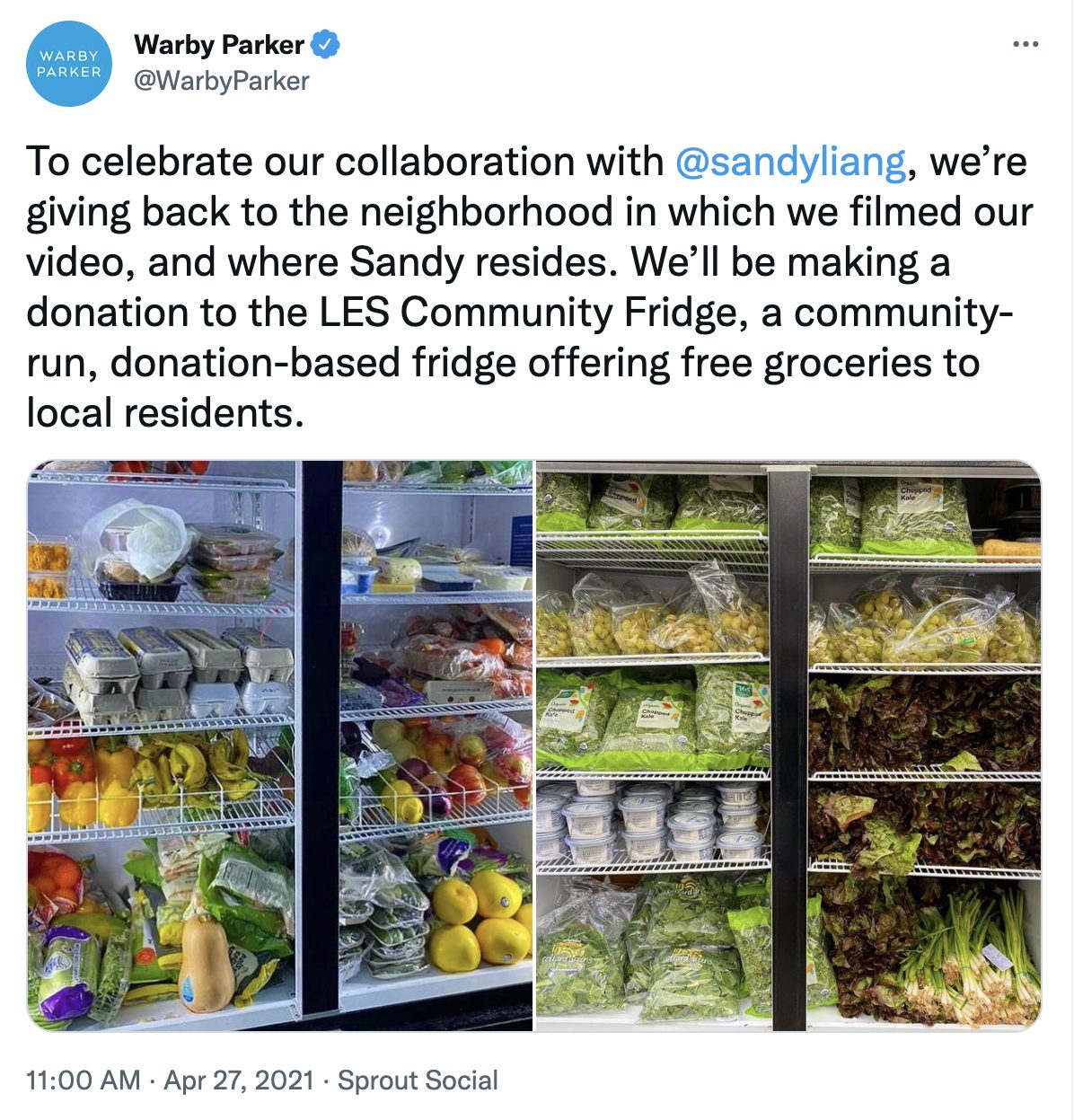 Tweet from Warby Parker announcing a collaboration with designer Sandy Liang and a donation to the LES Community Fridge. The attached photo shows two large community refrigerators filled with groceries: eggs, produce like squash, peppers, oranges, grapes, leafy greens, and packaged salads.