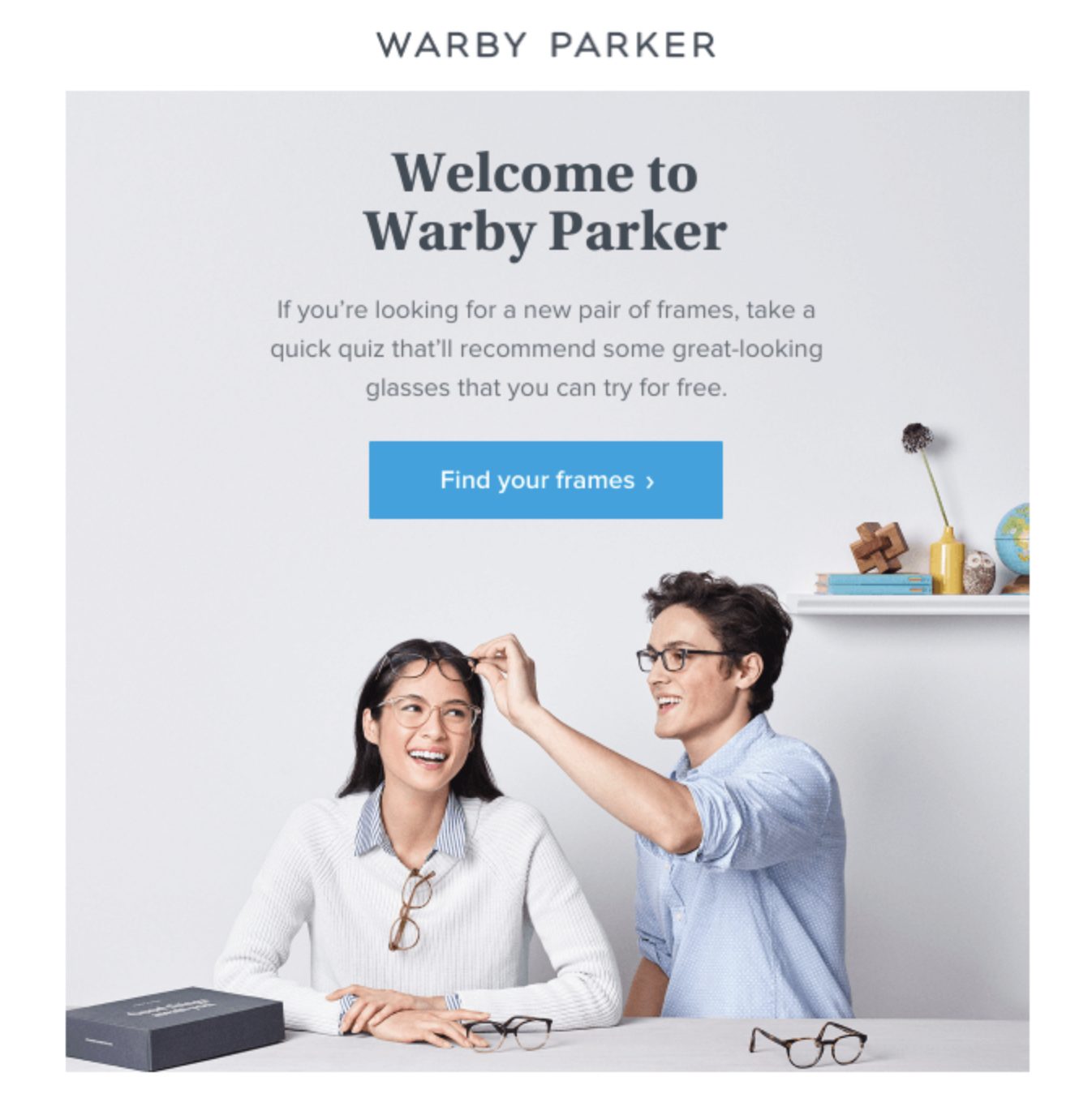 Warby Parker welcome email featuring a headline ‘Welcome to Warby Parker,’ a call-to-action button to find frames, and an image of two smiling people trying on glasses. 