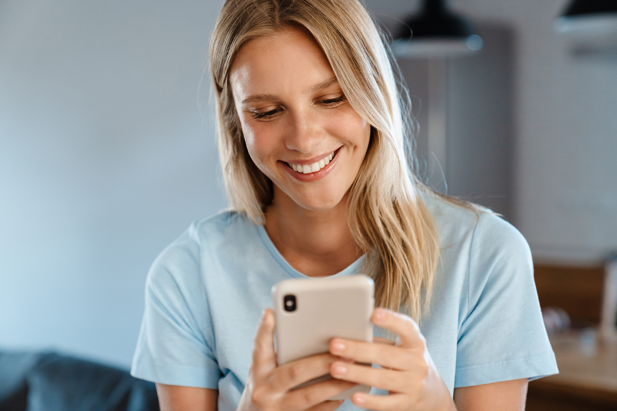 woman smiling on her phone