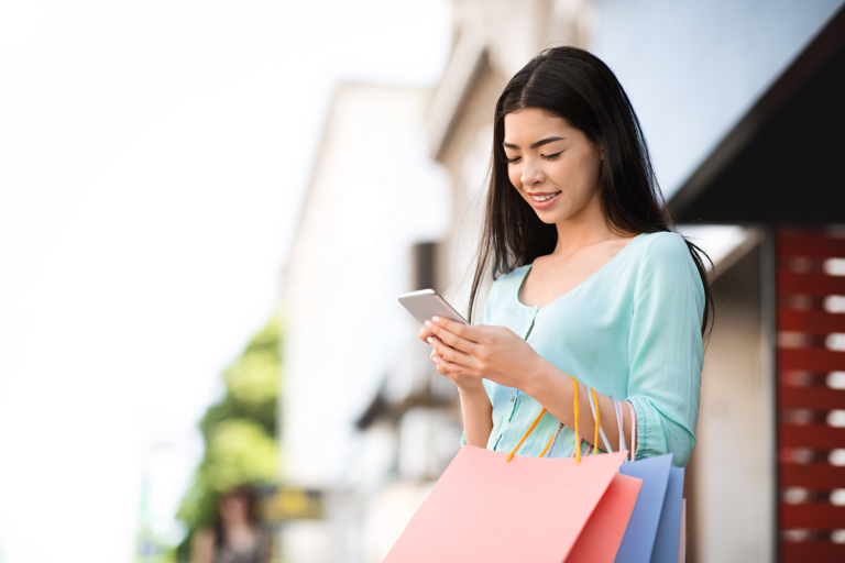 Woman smiling carrying her shopping bags