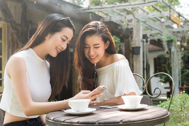 two ladies looking at the phone