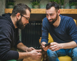 Two Friends Watching Content In A Smart Phone