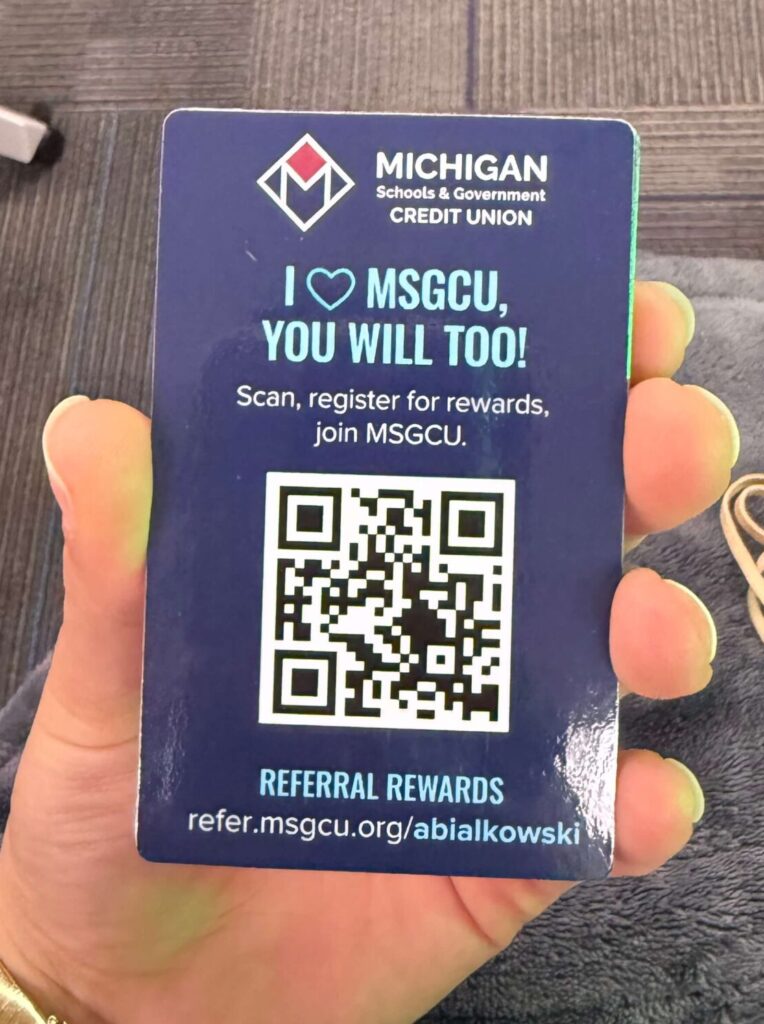 Back of MSGCU referral program example card displaying a QR code that new members can scan to register for rewards and join the Michigan Schools & Government Credit Union.