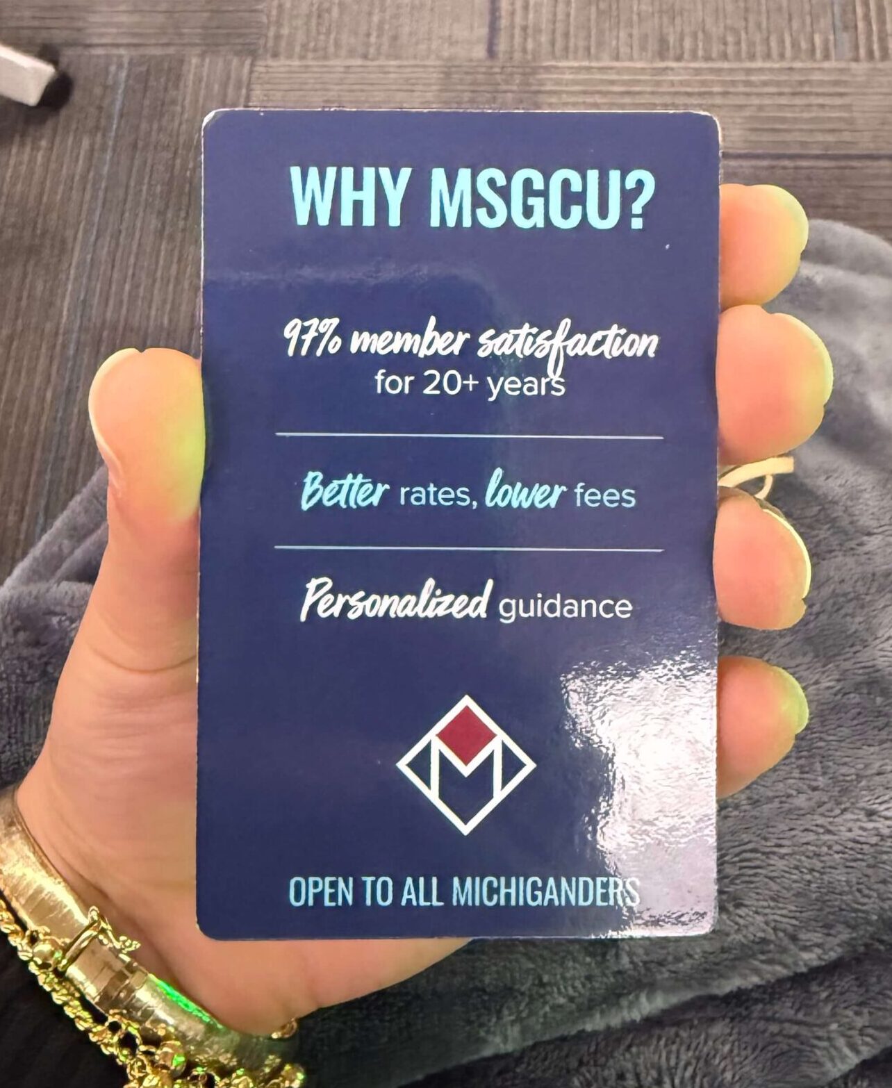 Front side of an MSGCU referral program example card highlighting benefits such as 97% member satisfaction, better rates, lower fees, and personalized guidance for Michigan residents.