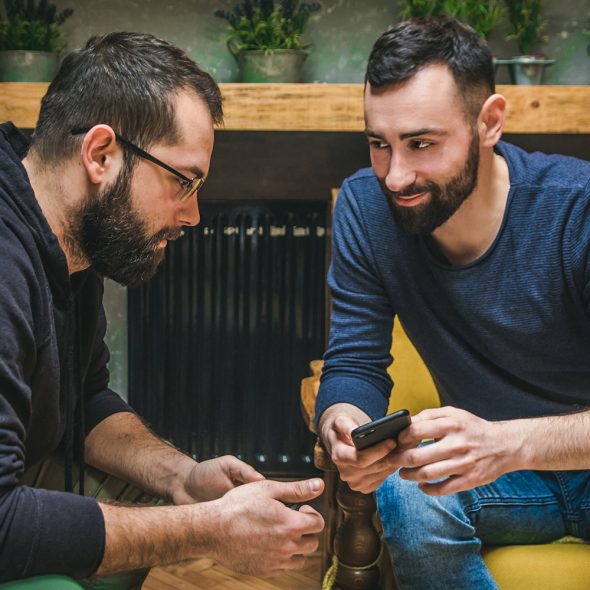 Two Friends Watching Content In A Smart Phone